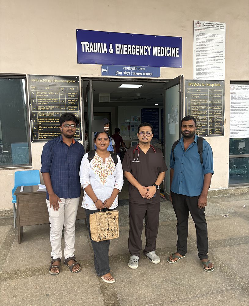 Members of the lab with a clinician at the entrance to the Department of Trauma and Emergency Medicine, AIIMS Guwahati.