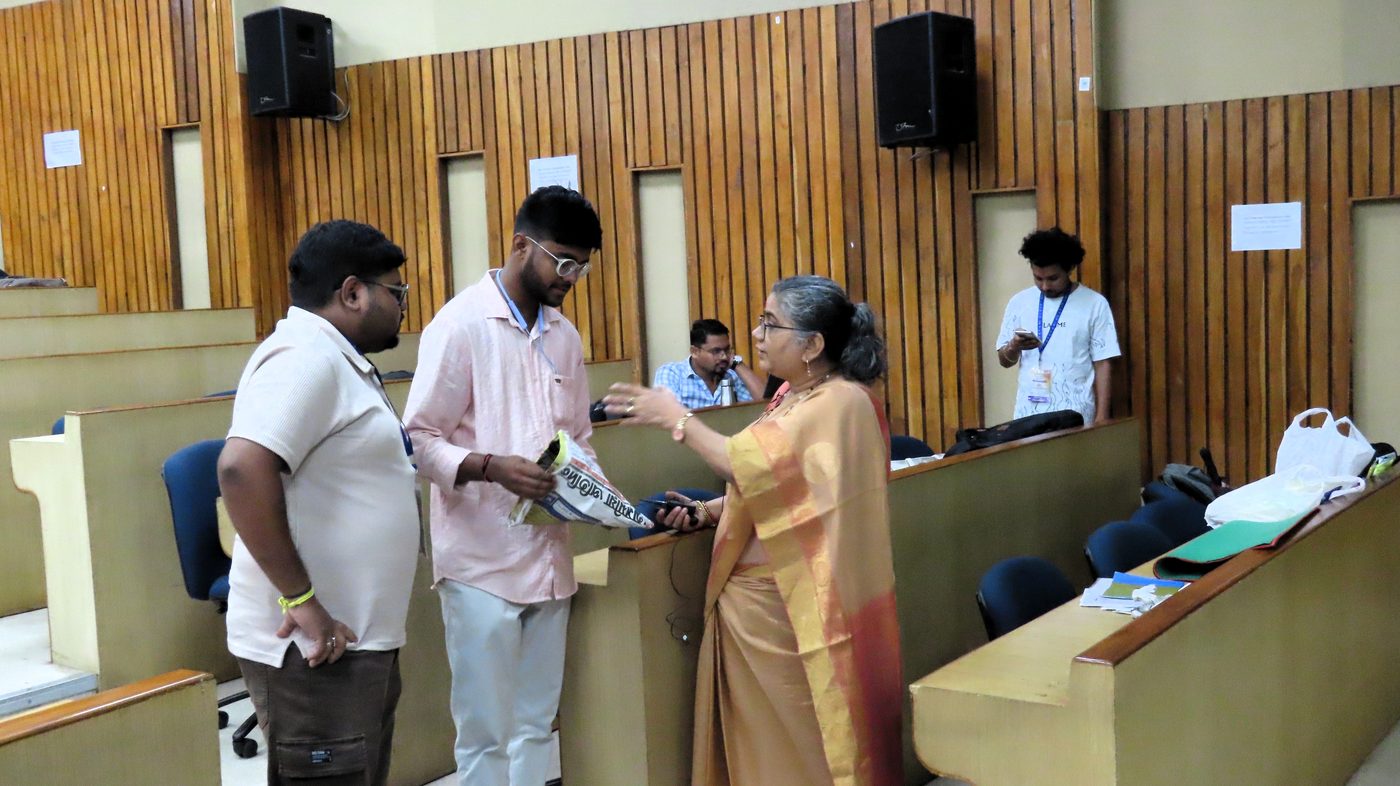 Participants discussing with a speaker during Day 4
